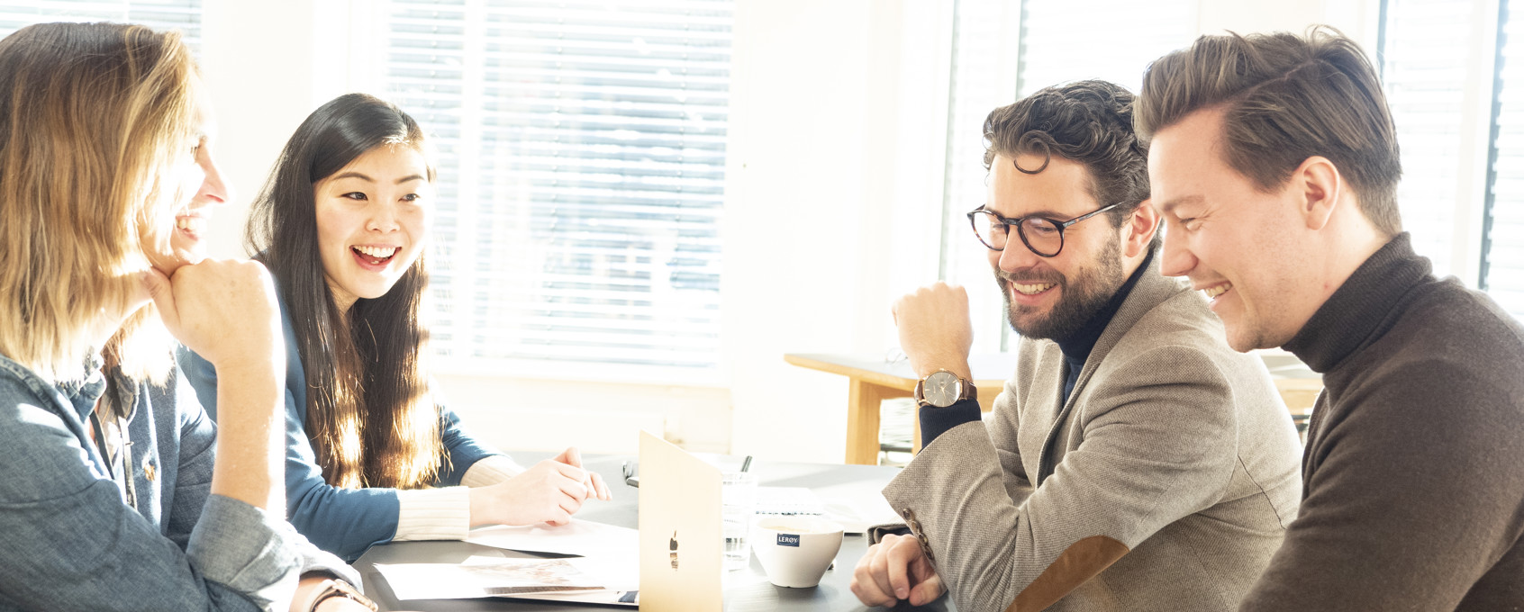 Ansatte rundt et bord i kontorlokalet